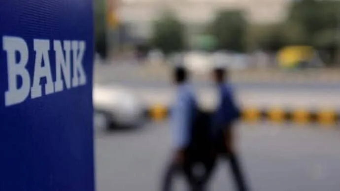Bank employees and customers at an Indian bank branch as five-day banking week talks begin