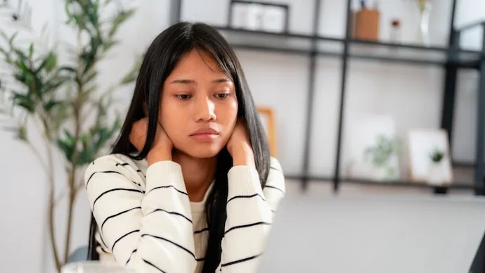 A working professional experiencing emotional exhaustion while managing everyday responsibilities and workplace demands.